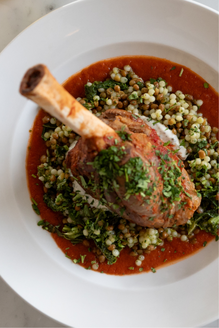 Braised lamb shank – Couscous, lentils, spinach, tomato-lamb jus, roasted garlic labneh